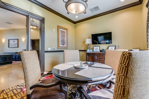 A well-furnished common area with a dining table and decor
