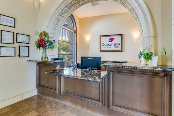 Reception area with a front desk and plants