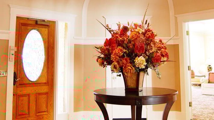 Elegant floral arrangement in a facility lobby.