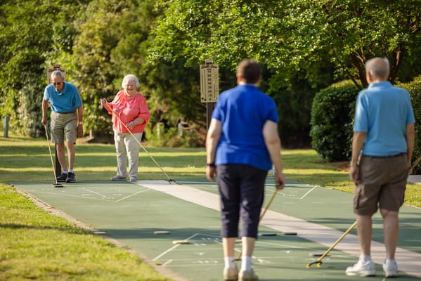 Residents playing outdoor games in a green space
