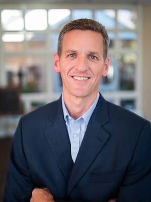 Professional staff member smiling in a lobby area