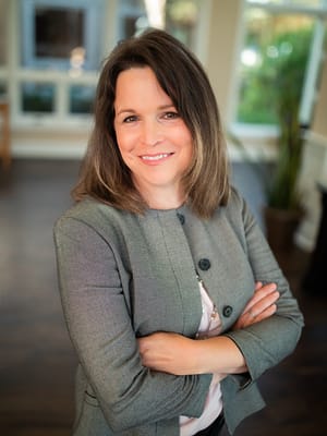 Staff member posing in a bright facility interior