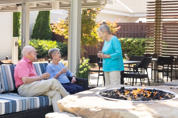 Residents enjoying drinks in an outdoor lounge area