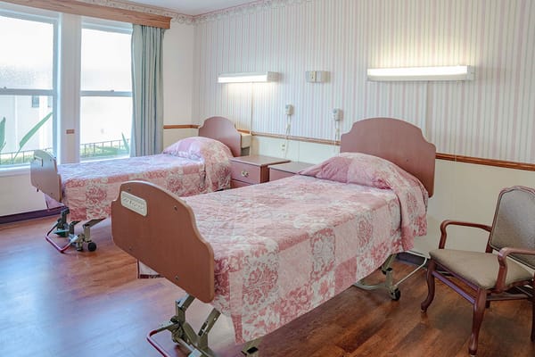 A well-furnished resident room with two beds