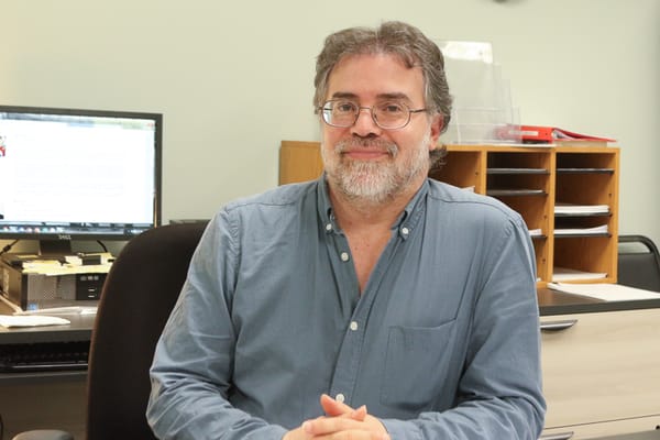 A staff member sitting in an office environment