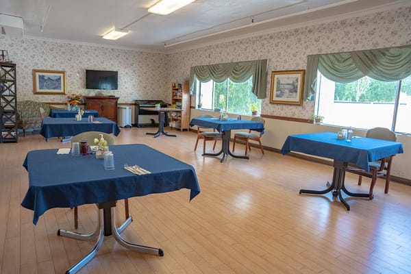 Dining area with tables set for residents