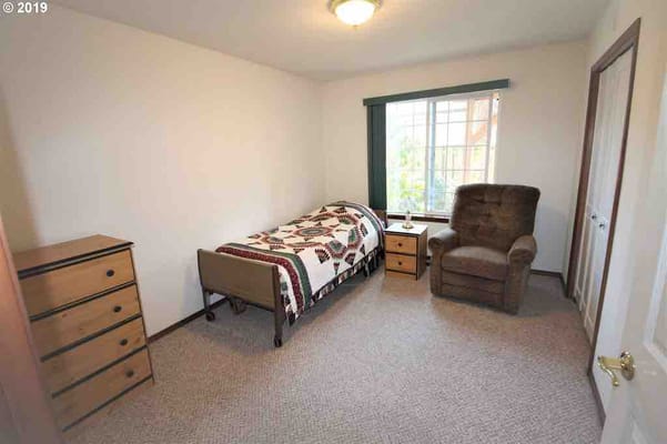 Cozy private room with single bed and chair