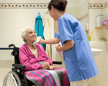 Caregiver assisting an elderly resident in a bathroom