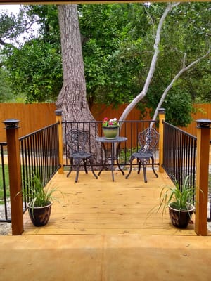 Outdoor seating area with plants and a table