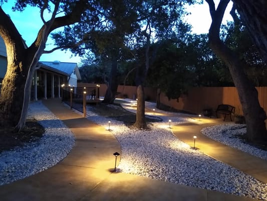 Well-lit outdoor path with landscaping at the facility