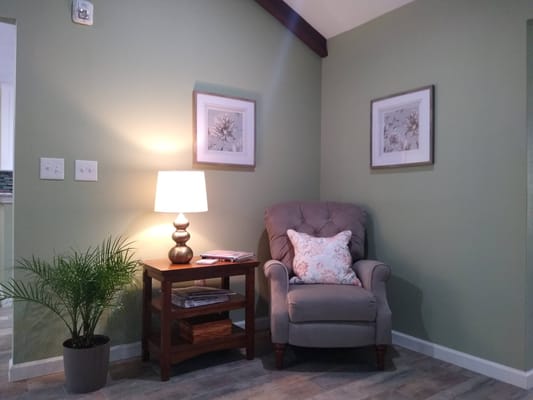 Cozy common area with comfortable chair and lamp