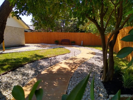 Pathway in a serene garden surrounded by trees