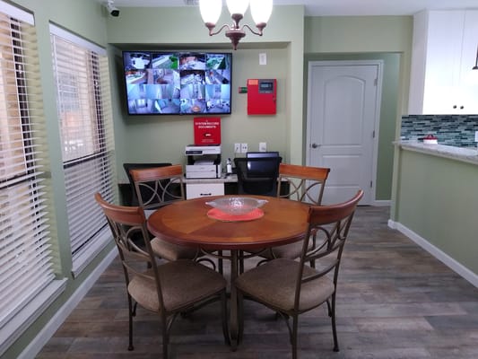 Common area with a table and wall-mounted monitors