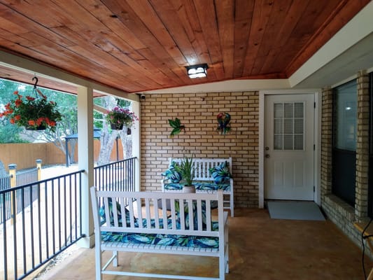 Outdoor patio area with seating and plants