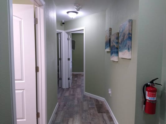 Hallway with green walls and fire extinguisher