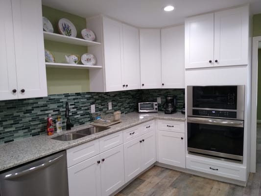 Modern kitchen interior with white cabinets and granite countertops