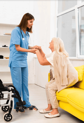 Healthcare worker assisting a resident in a cozy interior setting