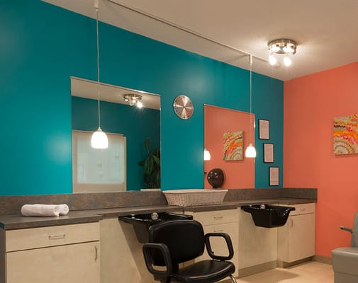 Brightly colored hair salon interior with styling stations