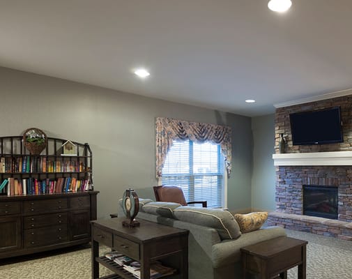 Cozy common area with a fireplace and bookshelves