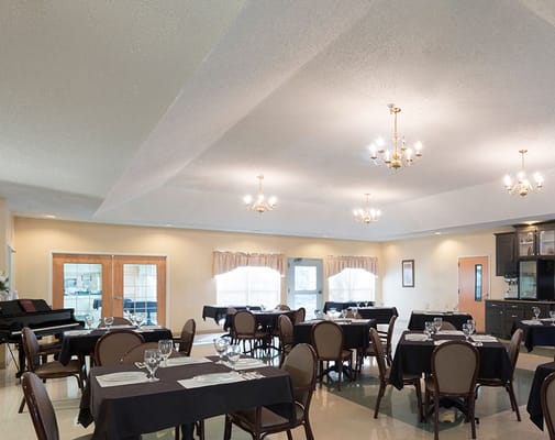 Dining area set up for a meal with tables and chairs