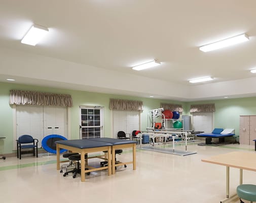 A therapy room with equipment and seating