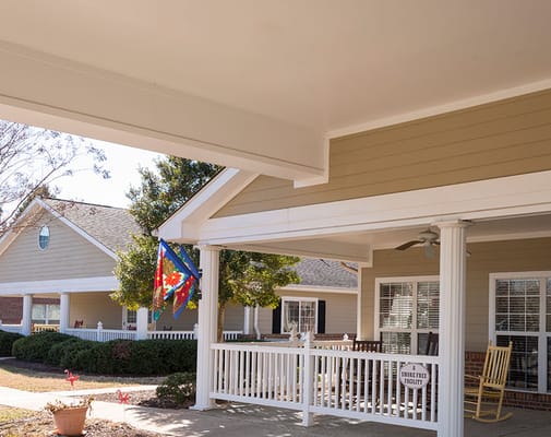 Front porch of a senior living facility with flags