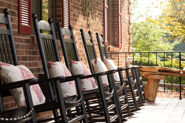 Rocking chairs on a porch with decorative pillows