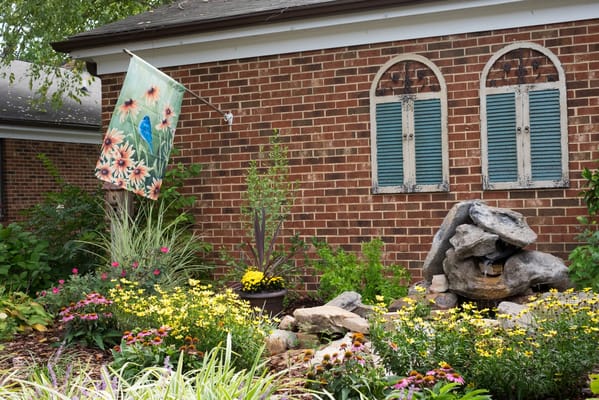 Beautiful outdoor garden area with flowers and a stone feature