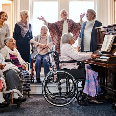 Residents singing together in a vibrant common area