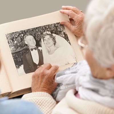 Elderly couple looking at a wedding photo together