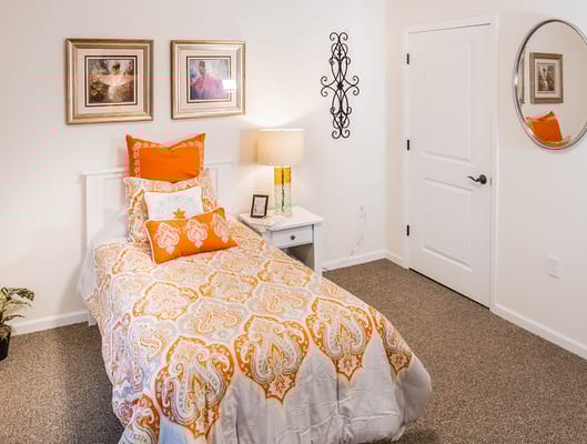 Cozy private resident room with decorative bedding