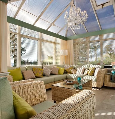 Bright sunroom with comfortable seating and decor