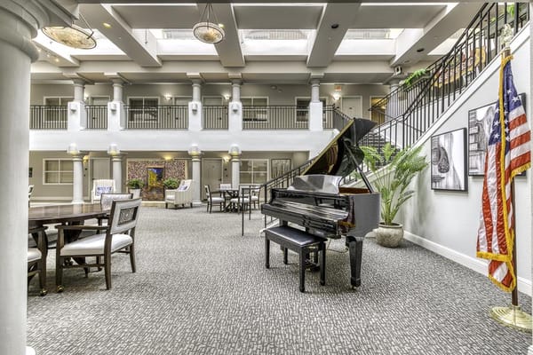 Spacious common area with a piano and seating