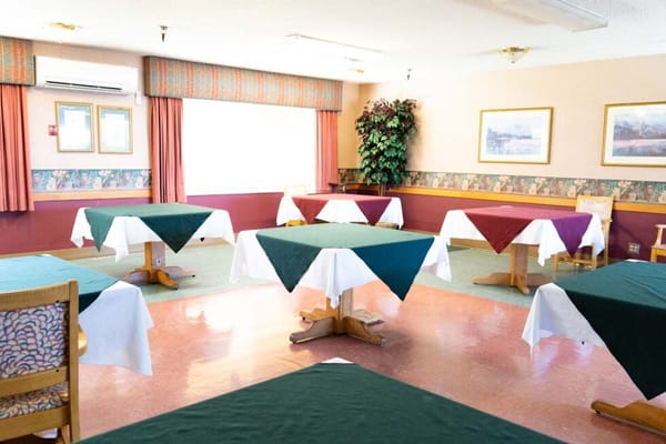 Bright dining room with tables set for meals