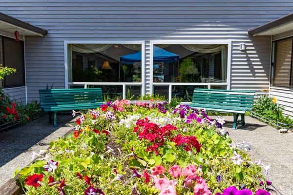 Bright garden area with colorful flowers and seating