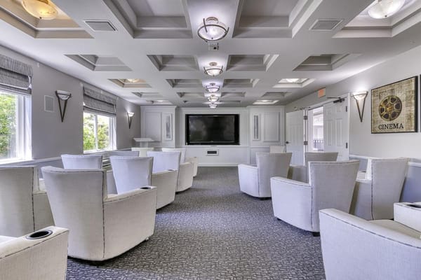 Bright common area with plush seating and TV