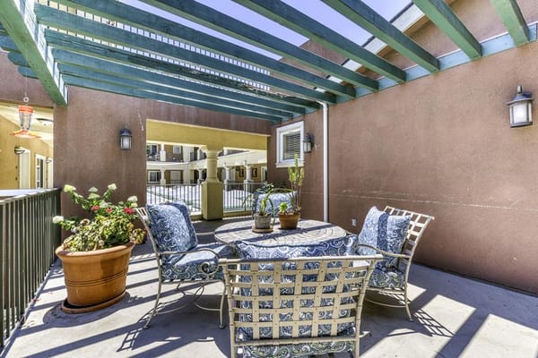 Outdoor seating area with plants in a senior living facility