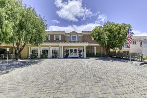 Front entrance of a senior living facility with landscaping