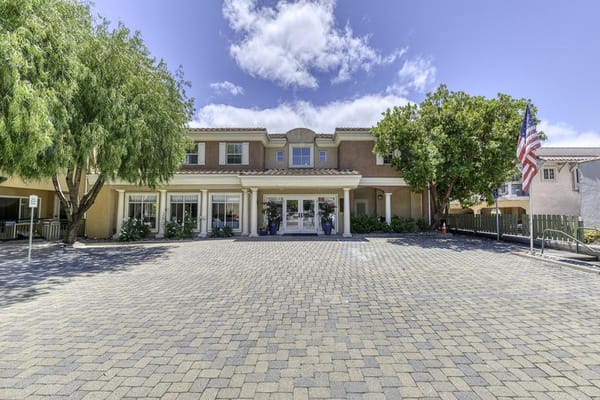 Front entrance of a senior living facility with landscaping
