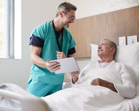 Caregiver assisting a senior resident in a room