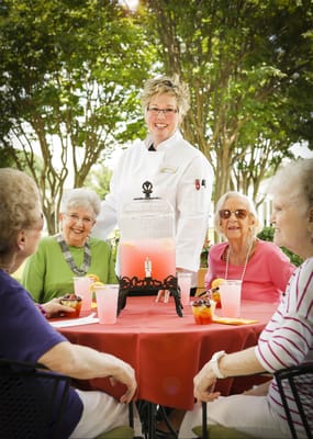 Residents enjoying drinks and desserts in the garden