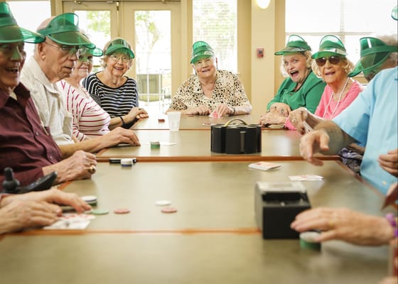 Residents enjoying a game in a bright activity room