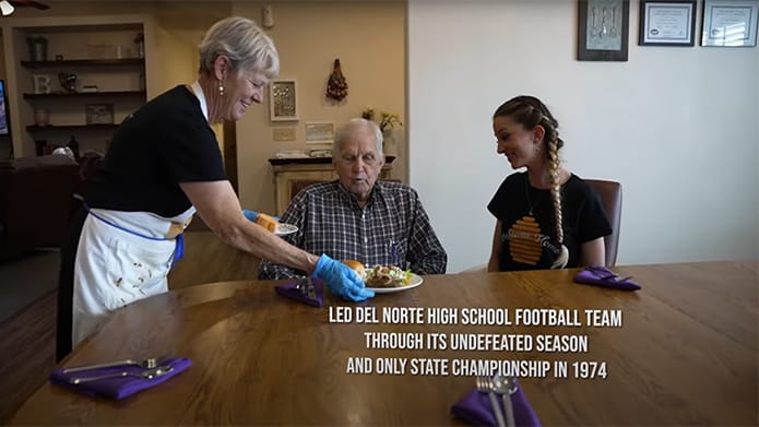 Staff serving a meal to a resident