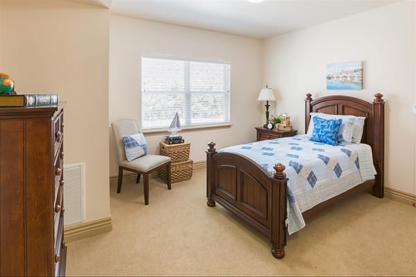 Cozy resident bedroom with wooden furniture and a scenic painting
