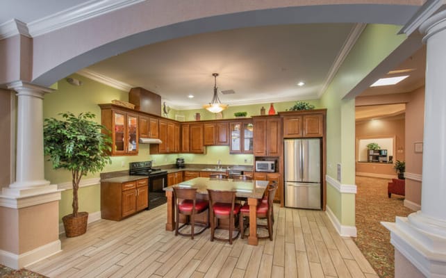 Bright kitchen area with wooden cabinets and seating