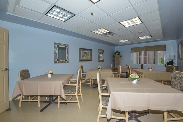 Bright dining room with tables set up for residents