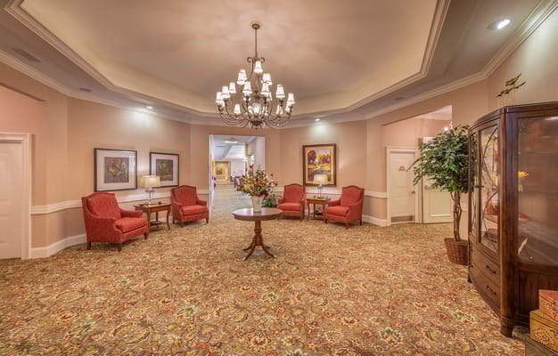 Bright and inviting lobby area with chairs and flowers