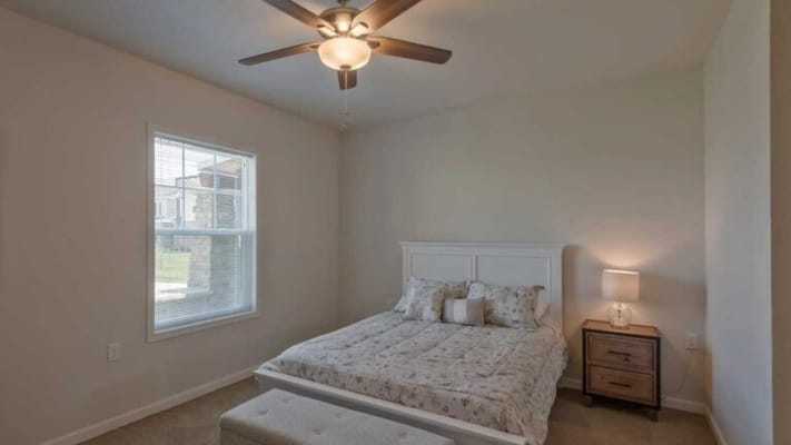 Cozy private resident room with a bed and lamp