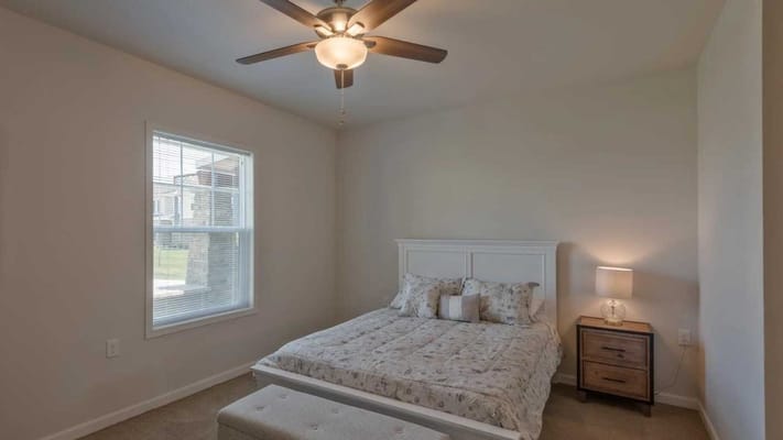 Cozy private resident room with a bed and lamp