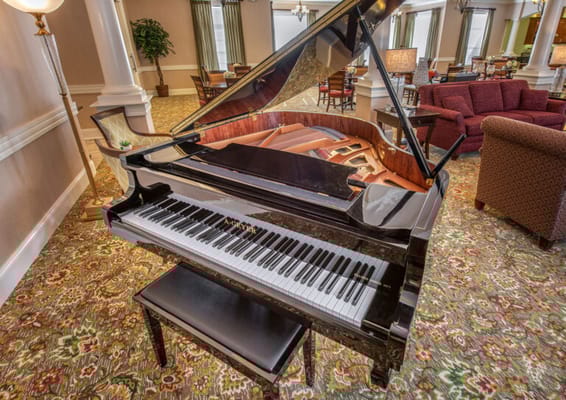A grand piano in a cozy common area